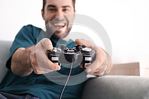 Young man playing video games at home