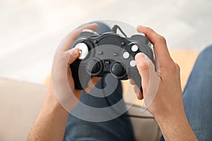 Young man playing video games at home