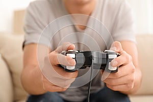 Young man playing video games at home