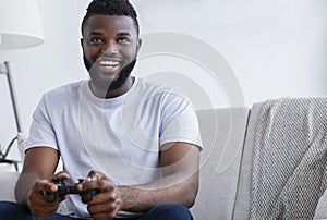 Young man playing video games at home