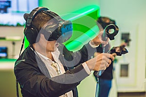 Young man playing video games virtual reality glasses. Cheerful