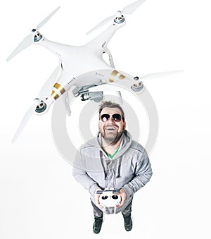 Young man playing a white drone