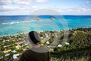 Young man point of view Lanikai from the Pillbox hiking trail Kailua Hawaii in December