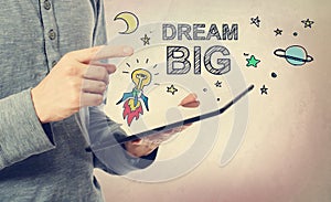 Young man pointing at Dream BIG concept