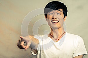 Young man pointing and laughing