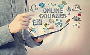 Young man pointing at Online Courses concept photo