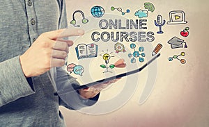 Young man pointing at Online Courses concept