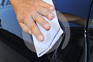 Young man polishing a car