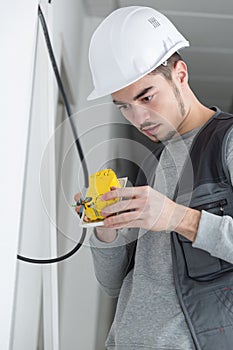 Young man pondering how to connect switch