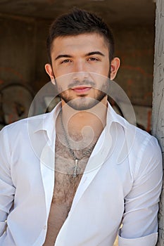 Young man portrait in unbuttoned shirt