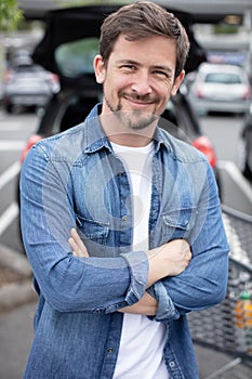 young man posing while going to supermarket