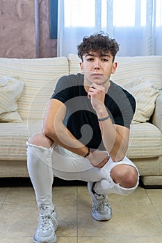 Young man posing on a living room sofa