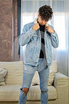 Young man posing on a living room sofa