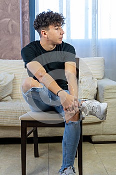 Young man posing on a living room sofa