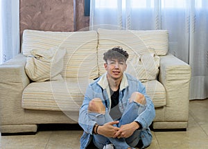 Young man posing on a living room sofa