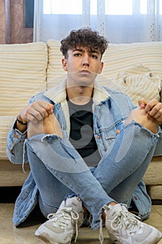 Young man posing on a living room sofa