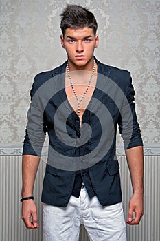 Young man posing in studio dressed in a suit