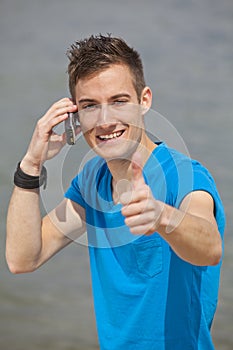 Young man posing thumbs up