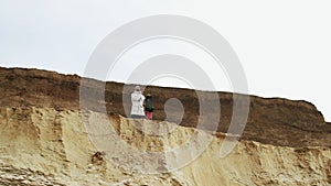 Young man posing witn sandboard in desert or sand quarry