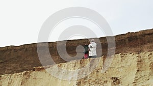 Young man posing witn sandboard in desert or sand quarry