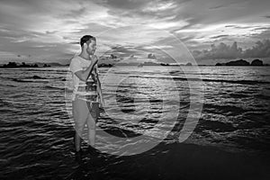 Young man posses at Ao Nang Beach, Krabi, Thailand