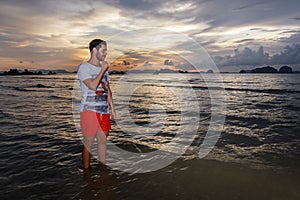 Young man posses at Ao Nang Beach, Krabi, Thailand