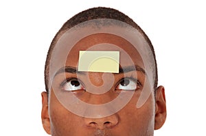 Young man with post it on his forehead