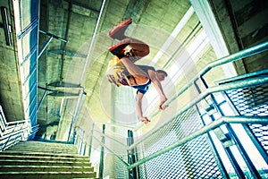 Young man practice parkour jump in the city