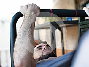 Young man practices physical activity during quarantine. Sportsman exercising on the balcony in isolation because of the covid-19