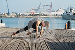 Young man practices yoga to relax from the stress of the city and exercise