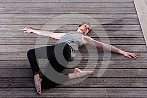 Young man practices yoga to relax from the stress of the city and exercise