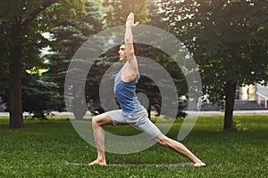 Young man practicing yoga outdoors