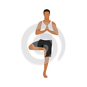 Young man practicing yoga with tree pose, vrksasana asana,