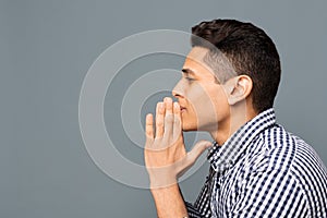 Young Man Praying And Asking For Something, Side View