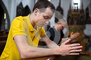 Young man praying in a church