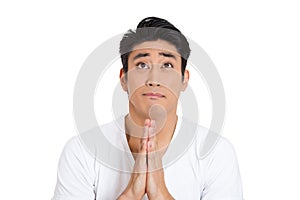 young man praying hands clasped hoping for best asking for forgiveness or miracle isolated on white background