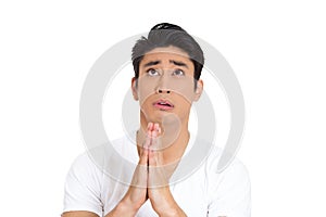 young man praying hands clasped hoping for best asking for forgiveness or miracle isolated on white background