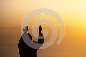 Young man praying in the morning, Hands folded in prayer concept for faith, spirituality and religion