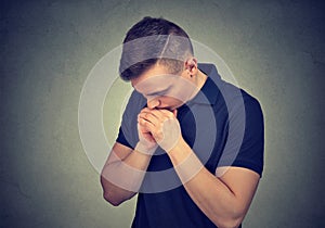 Young man praying in silence