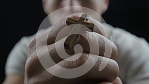 Young man praying to God. Concept of faith and religion