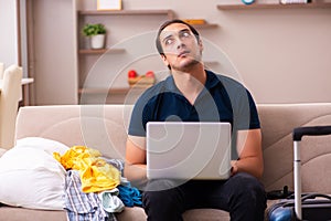 Young man preparing for journey at home