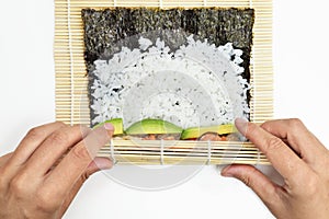 Young man preparing makizushi