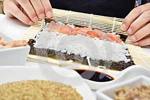 Young man preparing makizushi