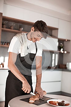 Young man preparing a sandwich in the kitchen