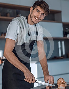 Young man preparing a sandwich in the kitchen