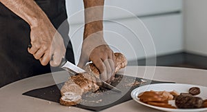 young man preparing a sandwich in the kitchen