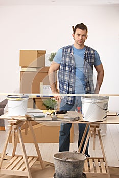 Young man preparing to paint new home