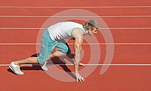 Young man preparing to run