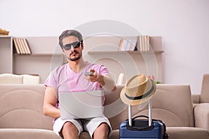Young man preparing for trip at home