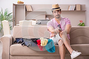 Young man preparing for trip at home